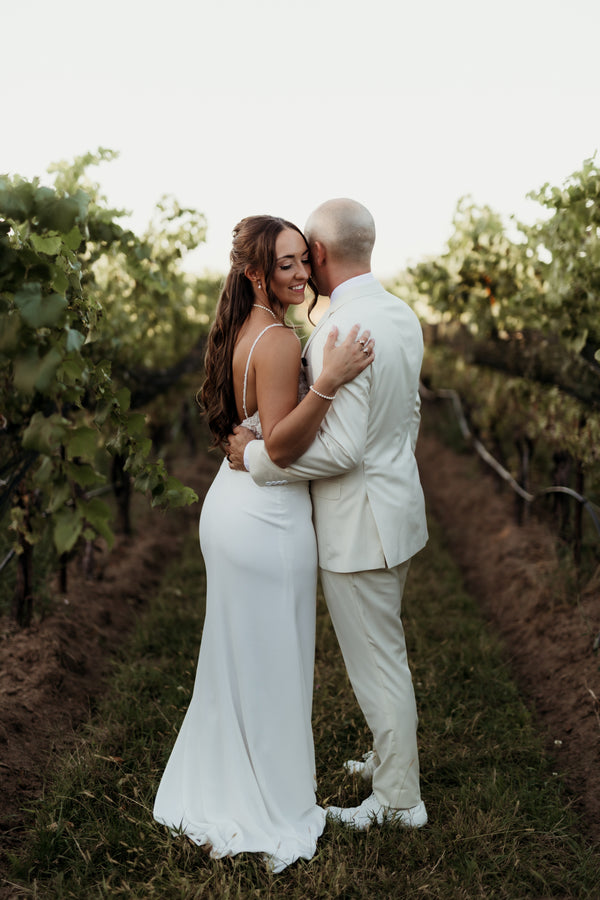 Couple walking between vineyard rows at Ravine Vineyard in St. Davids, Niagara-on-the-Lake